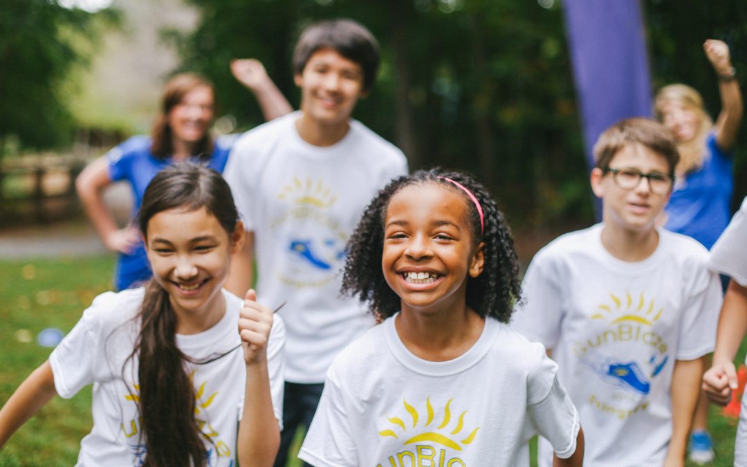 Students happily take part in an outdoor event, student leadership